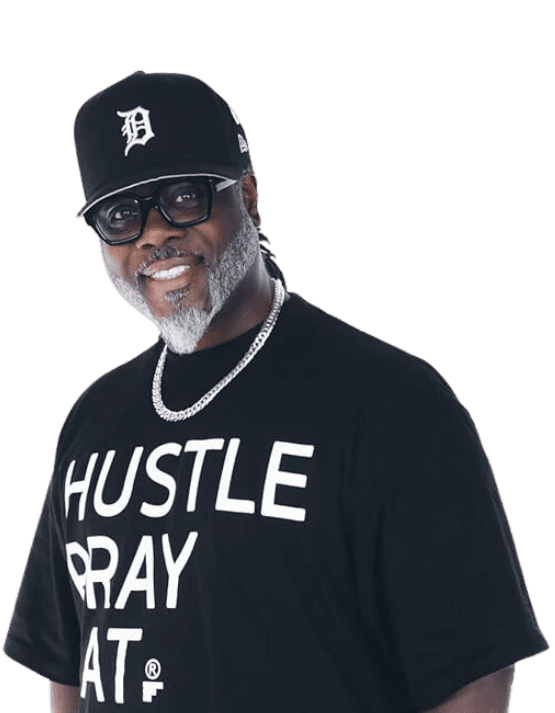 Troy Evans, a seasoned leader in urban ministry, wearing a 'Hustle Pray Eat' shirt and a Detroit cap.